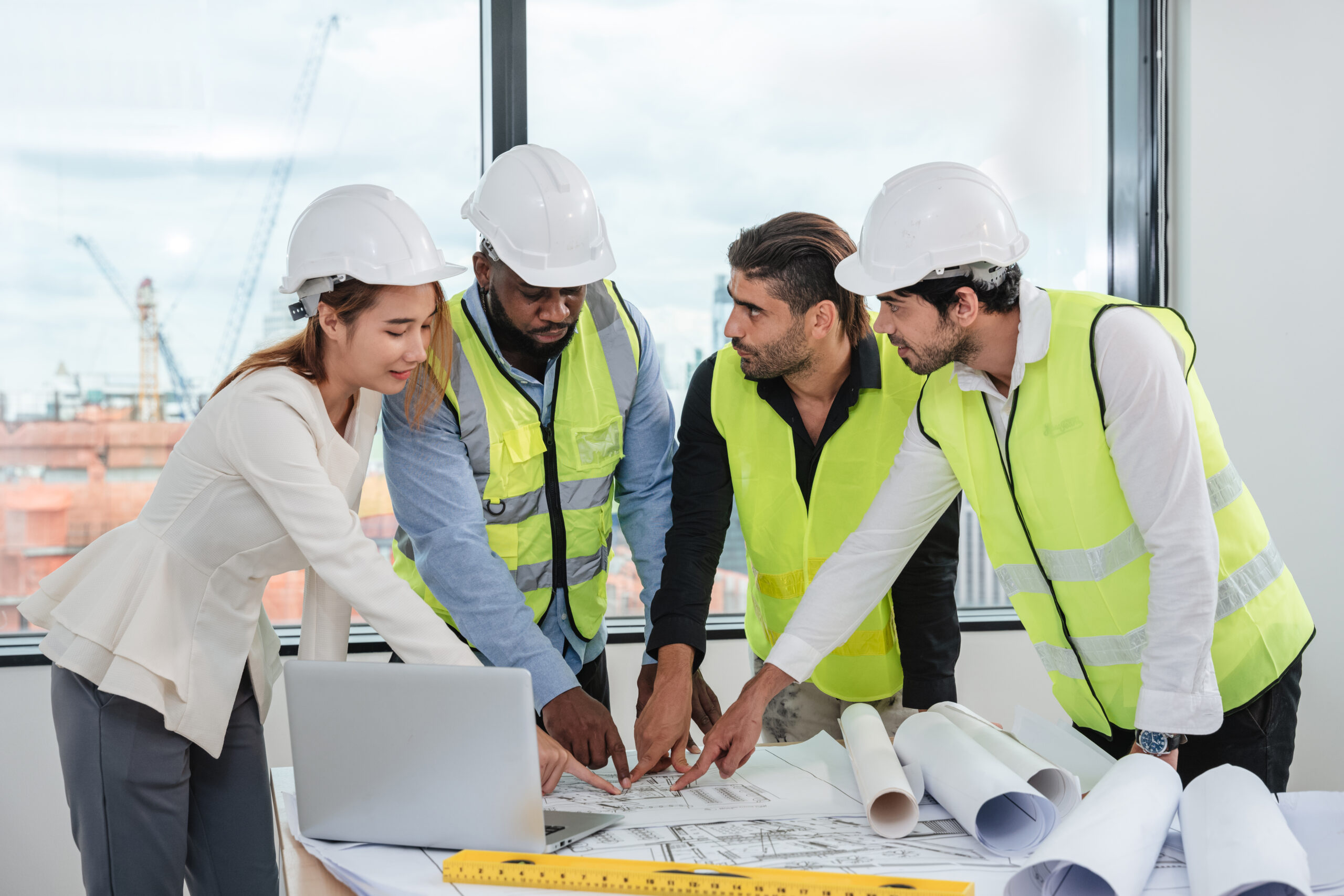 Engineers meet in the office to work on a project as a team.