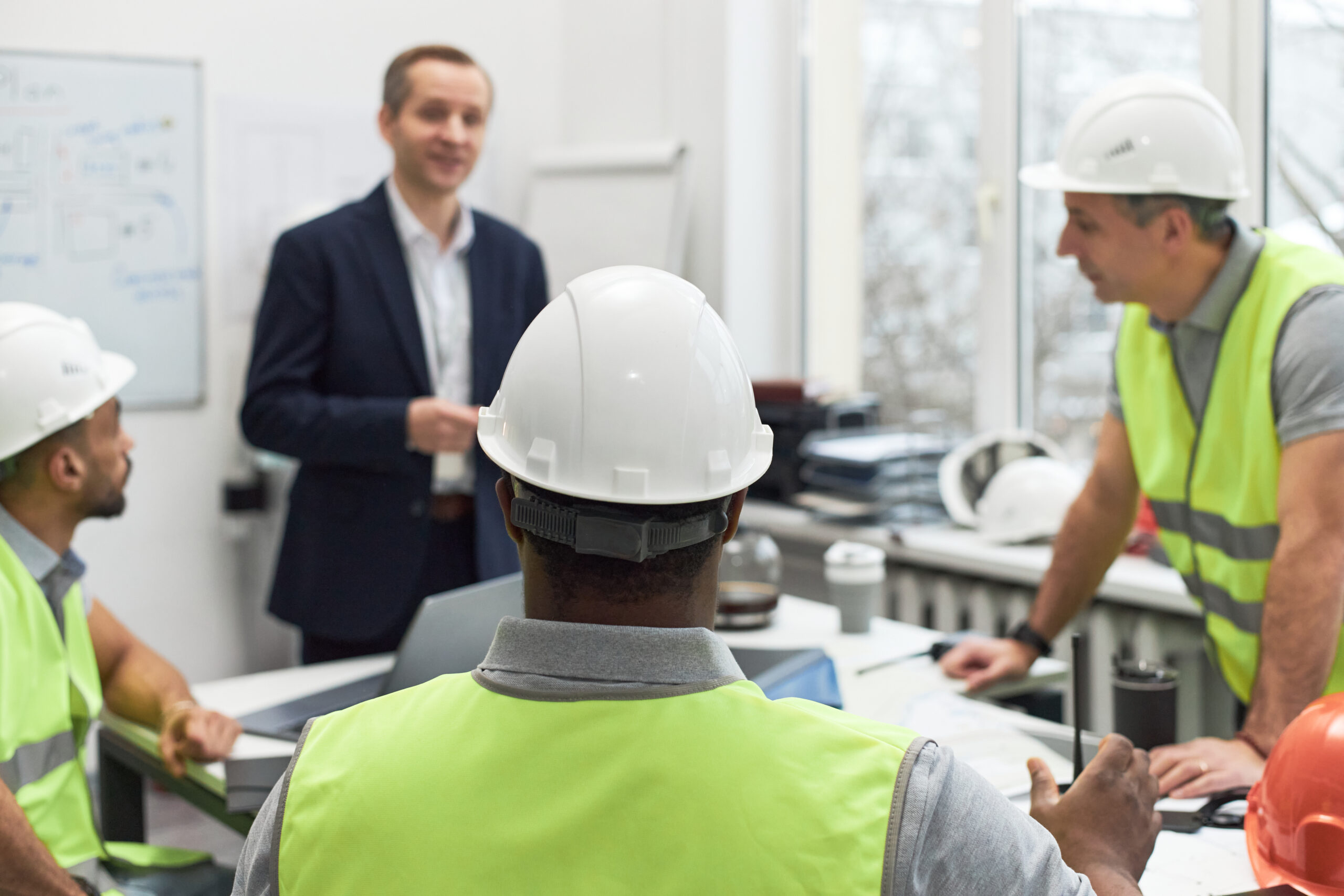 Engineers collaborating and discussing about the construction project for a client.
